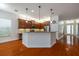 Open concept kitchen with breakfast bar and hardwood floors at 4943 Sandy Brook Cir, Wimauma, FL 33598