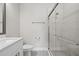 Bright bathroom featuring a glass-enclosed shower and white cabinets at 2510 W Cleveland St # 2, Tampa, FL 33609