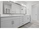 Bathroom features double sinks with white cabinets, a large mirror, and brushed silver hardware at 2510 W Cleveland St # 2, Tampa, FL 33609