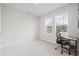 A sun-filled bedroom features carpet flooring, a modern desk, and windows with blinds at 2510 W Cleveland St # 2, Tampa, FL 33609