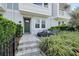 Inviting front yard with patio, stone walkway, and lush landscaping creates a welcoming entrance at 2510 W Cleveland St # 2, Tampa, FL 33609
