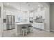 Bright kitchen features white cabinets, stainless steel appliances, pendant lights, an island, and stool seating at 2510 W Cleveland St # 2, Tampa, FL 33609