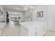Bright kitchen boasts an island, white cabinets, stainless appliances, herringbone backsplash, and open floor plan at 2510 W Cleveland St # 2, Tampa, FL 33609