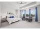 Spacious main bedroom features tray ceilings, ceiling fan, sitting area, large windows, and neutral carpeting at 2510 W Cleveland St # 2, Tampa, FL 33609