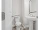 A well-lit powder room features a pedestal sink, stylish floor tiles, and charming decor at 2510 W Cleveland St # 2, Tampa, FL 33609