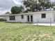 Back exterior of a house with a fenced in patio at 3245 Bigelow Dr Dr, Holiday, FL 34691