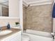 Cozy bathroom featuring a tub with tiled walls and a modern sink with bright counter at 3245 Bigelow Dr Dr, Holiday, FL 34691