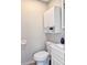 Clean bathroom with white cabinets, toilet, and a compact sink at 3245 Bigelow Dr Dr, Holiday, FL 34691