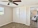 A neutral bedroom featuring a ceiling fan, wood floors, and a closet at 3245 Bigelow Dr Dr, Holiday, FL 34691