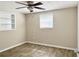 Cozy bedroom featuring wood-look floors, neutral walls, and a ceiling fan at 3245 Bigelow Dr Dr, Holiday, FL 34691