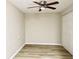 Bedroom with ceiling fan, closet, and wood-look flooring at 3245 Bigelow Dr Dr, Holiday, FL 34691