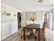 Inviting dining area featuring a stylish table, woven chairs, and neutral decor at 3245 Bigelow Dr Dr, Holiday, FL 34691