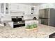Functional kitchen with stainless steel appliances, granite countertops, and ample cabinet space at 3245 Bigelow Dr Dr, Holiday, FL 34691