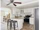 Modern kitchen with granite counters, stainless steel appliances, and a breakfast bar perfect for casual dining at 3245 Bigelow Dr Dr, Holiday, FL 34691