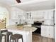 Well-lit kitchen featuring white cabinets, granite countertops, and stainless steel appliances at 3245 Bigelow Dr Dr, Holiday, FL 34691