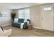 Charming living area with a blue sofa, neutral walls, and ample natural light at 3245 Bigelow Dr Dr, Holiday, FL 34691