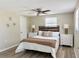 Comfortable main bedroom with decorative lamps, wood-look floors, and a ceiling fan at 3245 Bigelow Dr Dr, Holiday, FL 34691