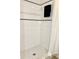 Tiled shower stall with black accent trim and neutral colored shower curtain at 3245 Bigelow Dr Dr, Holiday, FL 34691