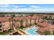 Aerial view showcases the complex with its tile roofs, pool, docks and lush landscaping at 5000 Culbreath Key Way # 4-306, Tampa, FL 33611