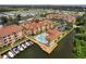 Aerial view showcases a pool, boat docks, water views, and condo community at 5000 Culbreath Key Way # 4-306, Tampa, FL 33611