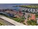 Aerial view of waterfront condo complex with a community pool, boat docks, and well-maintained grounds at 5000 Culbreath Key Way # 4-306, Tampa, FL 33611