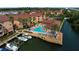 Stunning aerial view of waterfront condos featuring a pool, private boat slips, and beautifully landscaped grounds at 5000 Culbreath Key Way # 4-306, Tampa, FL 33611
