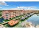 Aerial view shows a waterfront condo complex with private boat docks and ocean access at 5000 Culbreath Key Way # 4-306, Tampa, FL 33611