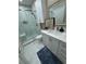 Modern bathroom featuring a walk-in glass shower and white vanity with framed mirror at 5000 Culbreath Key Way # 4-306, Tampa, FL 33611