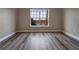 Bright bedroom with large window and hardwood floors, showing a view of the neighborhood at 5000 Culbreath Key Way # 4-306, Tampa, FL 33611