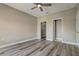 Bright, empty bedroom with wood-look floors, neutral paint, and closet space at 5000 Culbreath Key Way # 4-306, Tampa, FL 33611