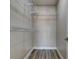 Walk-in closet with adjustable shelving system, offering ample storage space and hardwood floors at 5000 Culbreath Key Way # 4-306, Tampa, FL 33611