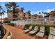 Condominiums with waterfront views feature lounge seating on wood deck with tropical landscaping at 5000 Culbreath Key Way # 4-306, Tampa, FL 33611