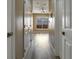 Hallway with doors and light hardwood floors, offering a glimpse of the open space at 5000 Culbreath Key Way # 4-306, Tampa, FL 33611