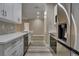 A bright kitchen features modern appliances, white cabinets, and stylish backsplash at 5000 Culbreath Key Way # 4-306, Tampa, FL 33611
