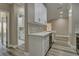 Modern kitchen featuring white cabinets, quartz countertops, stainless steel appliances, and a stylish backsplash at 5000 Culbreath Key Way # 4-306, Tampa, FL 33611