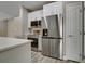 Modern kitchen features stainless steel appliances, quartz countertops, and white cabinetry for a sleek design at 5000 Culbreath Key Way # 4-306, Tampa, FL 33611