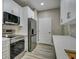 Modern kitchen featuring stainless steel appliances, white cabinets, and stylish backsplash at 5000 Culbreath Key Way # 4-306, Tampa, FL 33611