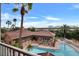 Community pool with lounge chairs and palm trees, with views of bridge and river at 5000 Culbreath Key Way # 4-306, Tampa, FL 33611