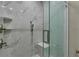 Walk-in shower is beautifully tiled and has a glass enclosure and a modern shower head at 5000 Culbreath Key Way # 4-306, Tampa, FL 33611