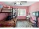 Pink bedroom with bunk beds, TV, and chevron flooring at 201 S Duncan Ave, Clearwater, FL 33755