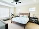 Main bedroom with king-size bed and ample natural light at 6515 Virginia Xing, University Park, FL 34201