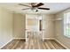 Spacious bedroom featuring a ceiling fan and access to other rooms at 3245 Bigelow Dr Dr, Holiday, FL 34691