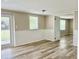 Bright living room with wood-look flooring and backyard access at 3245 Bigelow Dr Dr, Holiday, FL 34691