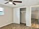Bedroom with wood-look floors, ceiling fan, and closet at 3245 Bigelow Dr Dr, Holiday, FL 34691