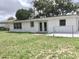 View of the back of the house and yard at 3245 Bigelow Dr Dr, Holiday, FL 34691