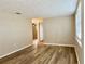 Living room with light walls, vinyl flooring, and an open doorway to another room at 3245 Bigelow Dr Dr, Holiday, FL 34691