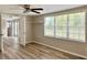 Bright bedroom with large window, ceiling fan and backyard view at 3245 Bigelow Dr Dr, Holiday, FL 34691