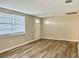 Living room with neutral walls, vinyl plank flooring, and a window with blinds at 3245 Bigelow Dr Dr, Holiday, FL 34691