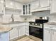 Updated kitchen featuring white cabinets, granite countertops, and stainless steel appliances at 3245 Bigelow Dr Dr, Holiday, FL 34691