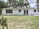 Back of house, featuring a large yard at 3245 Bigelow Dr Dr, Holiday, FL 34691